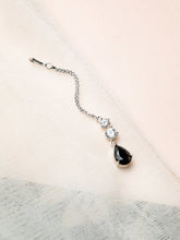 Silver Maang Tikka Design with black teardrop gem and clear stones on a light background