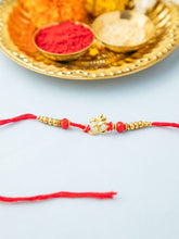 Radiant Golden Om Rakhi with Red Thread & Beads