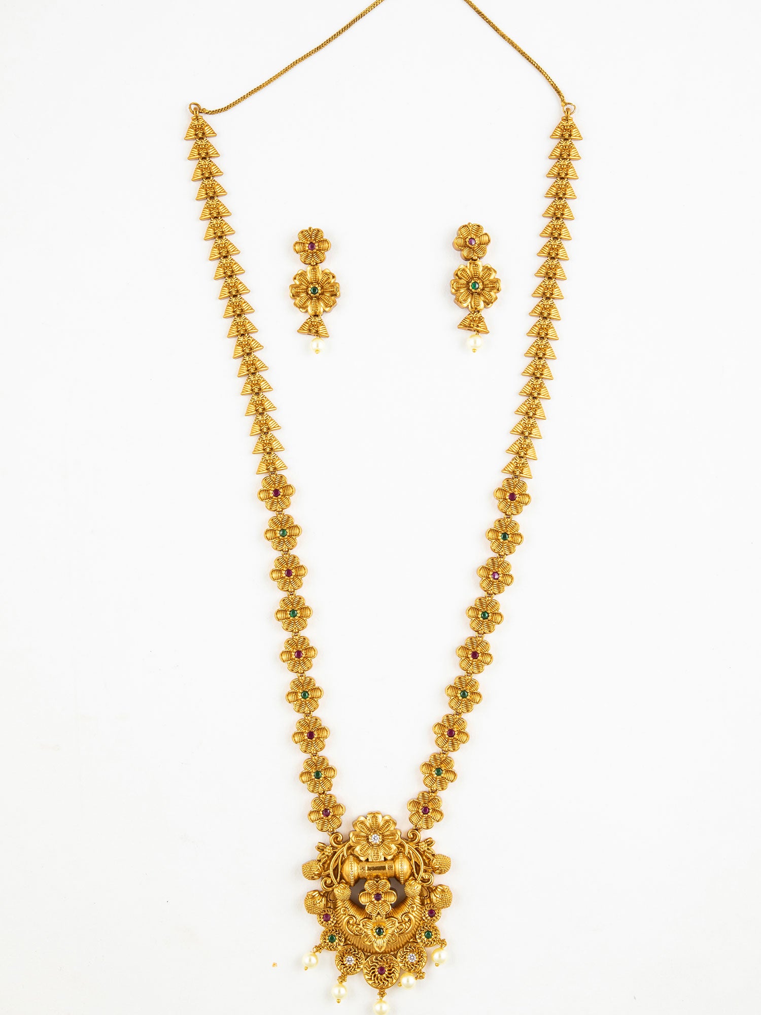Gold temple necklace set with floral design and matching earrings on a white background