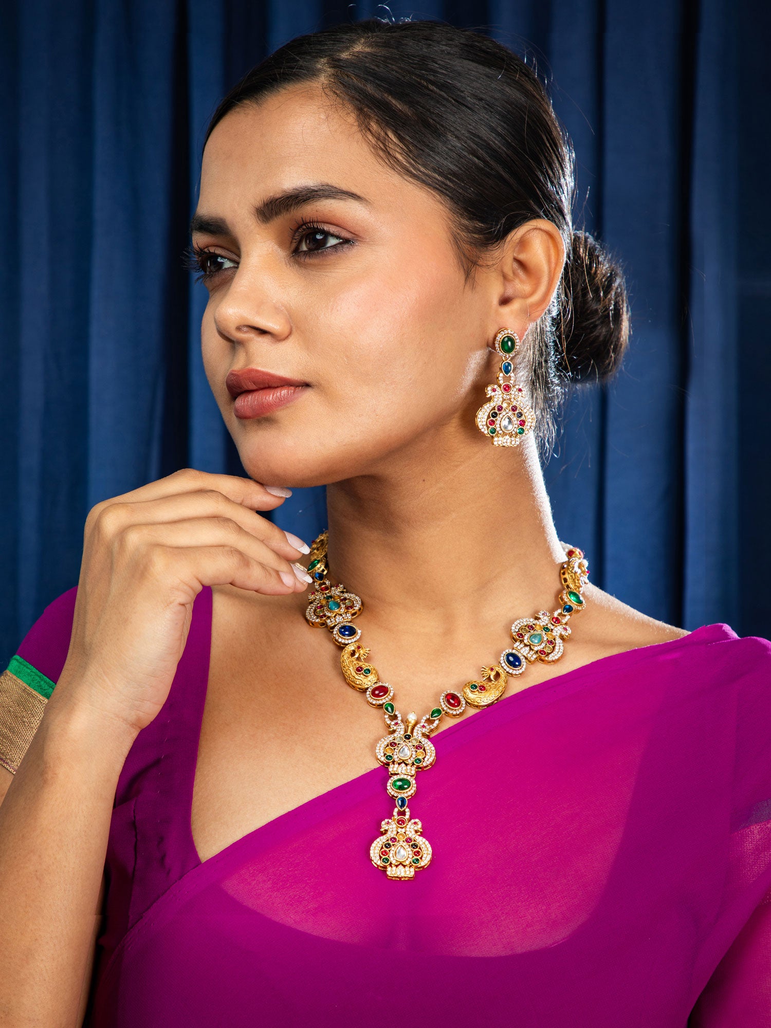 Women waring bridal peacock necklace set with gold plated jhumka earrings.