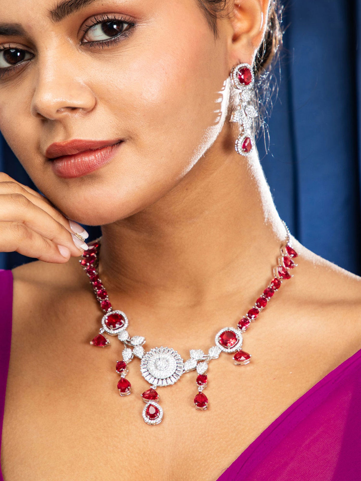 Women wearing premium red stone necklace set for bridal wear and special occasions