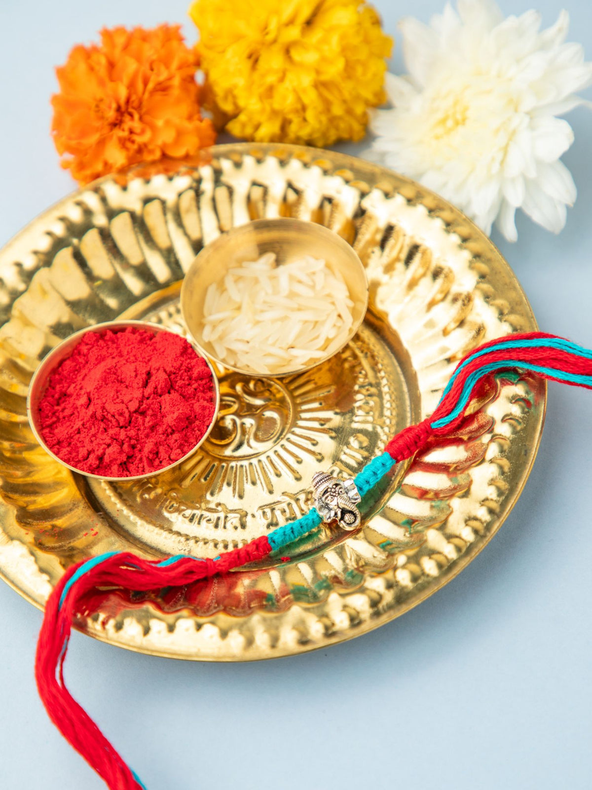 Divine Silver Ganesha Rakhi with Red & Blue Thread